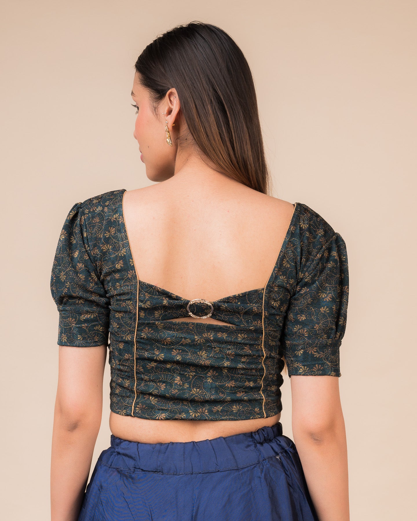 Rear view showcasing the buckle detail and peekaboo square back neckline