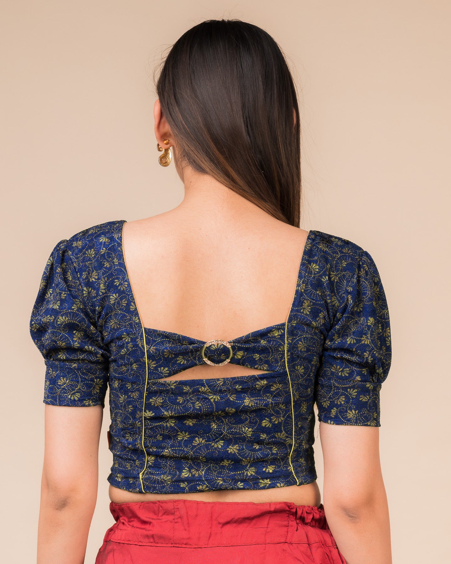 Rear view showcasing the buckle detail and peekaboo square back neckline