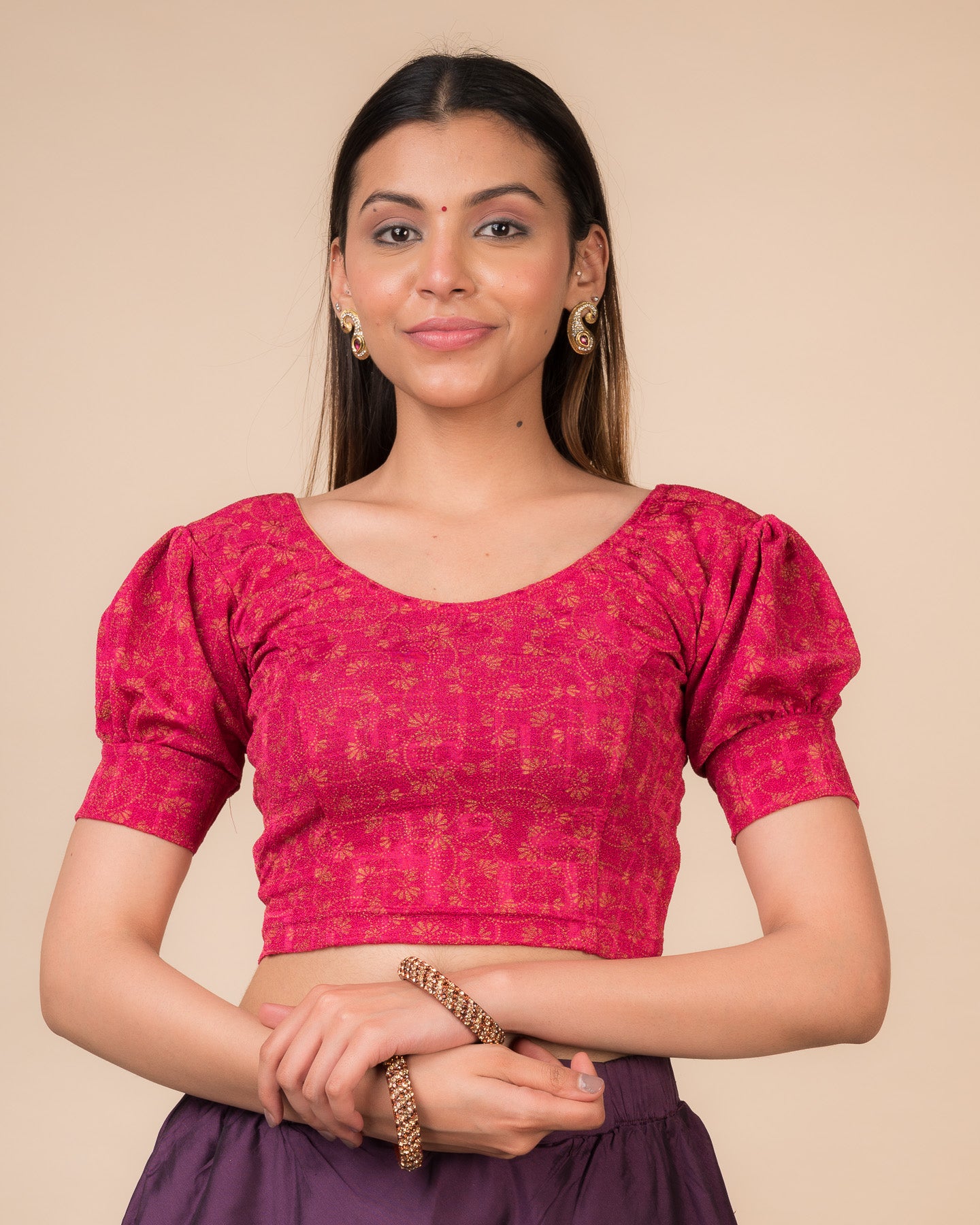Model wearing a navy stretchable blouse with elbow sleeves, metallic print, and round neckline