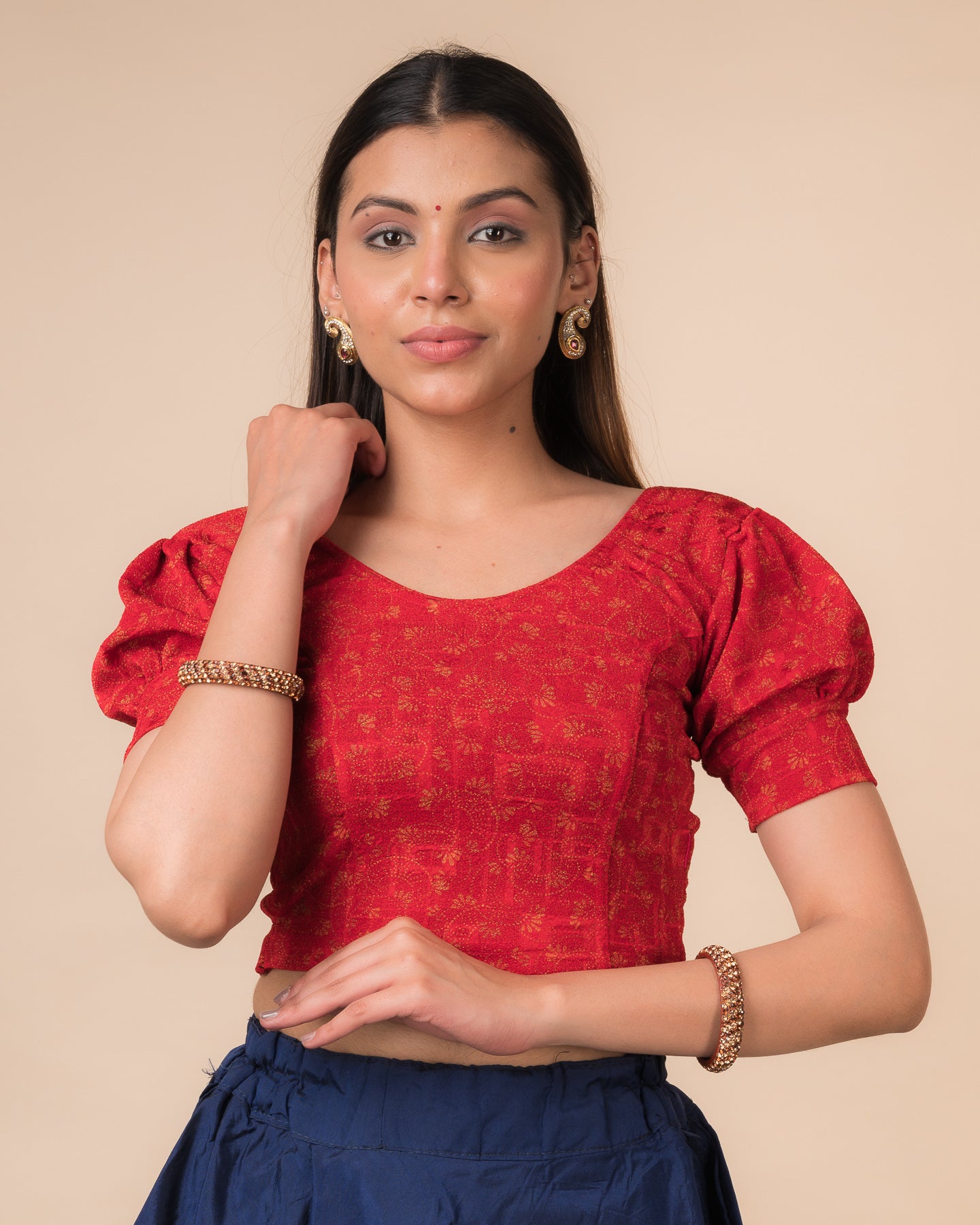 Model wearing a navy stretchable blouse with elbow sleeves, metallic print, and round neckline