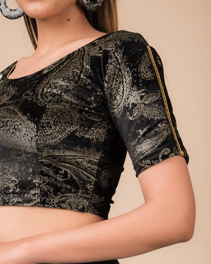 Close-up of velvet texture with gold paisley prints and gota accents