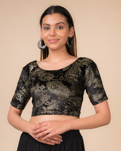 Model wearing a maroon velvet stretchable blouse with gold paisley prints, elbow sleeves, and round neckline.