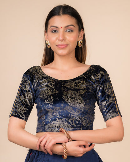 Model wearing a maroon velvet stretchable blouse with gold paisley prints, elbow sleeves, and round neckline.