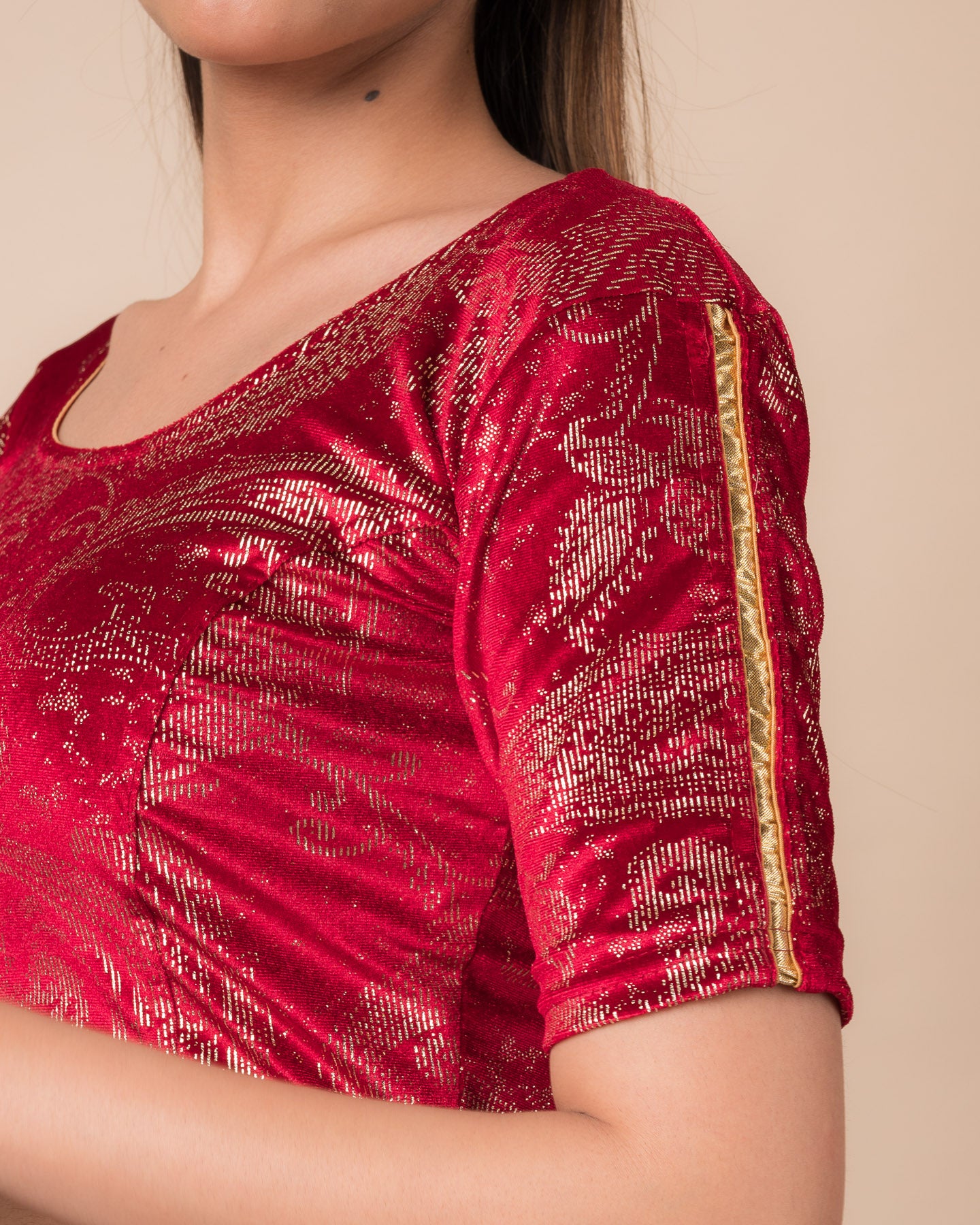 Close-up of velvet texture with gold paisley prints and gota accents