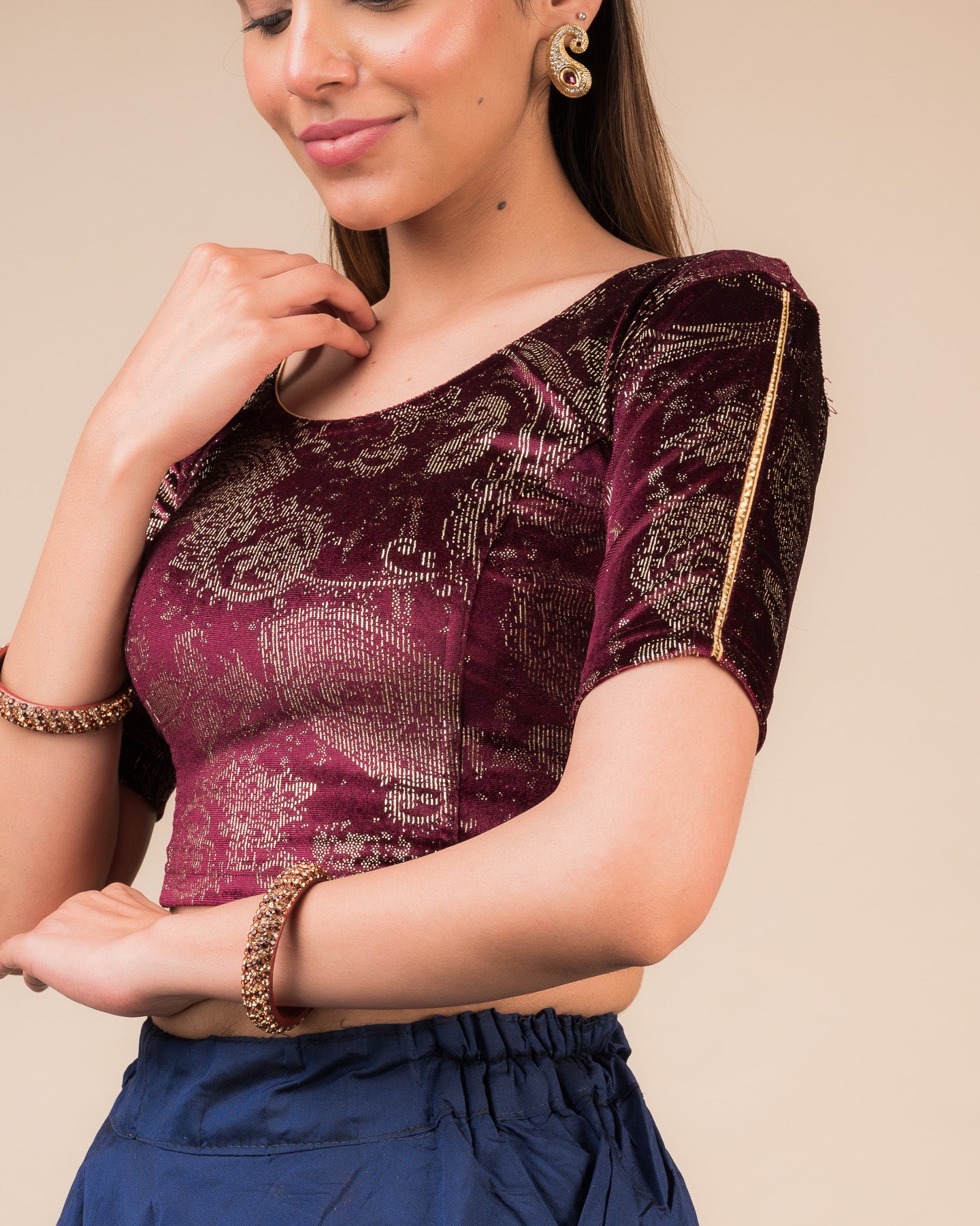 Close-up of velvet texture with gold paisley prints and gota accents