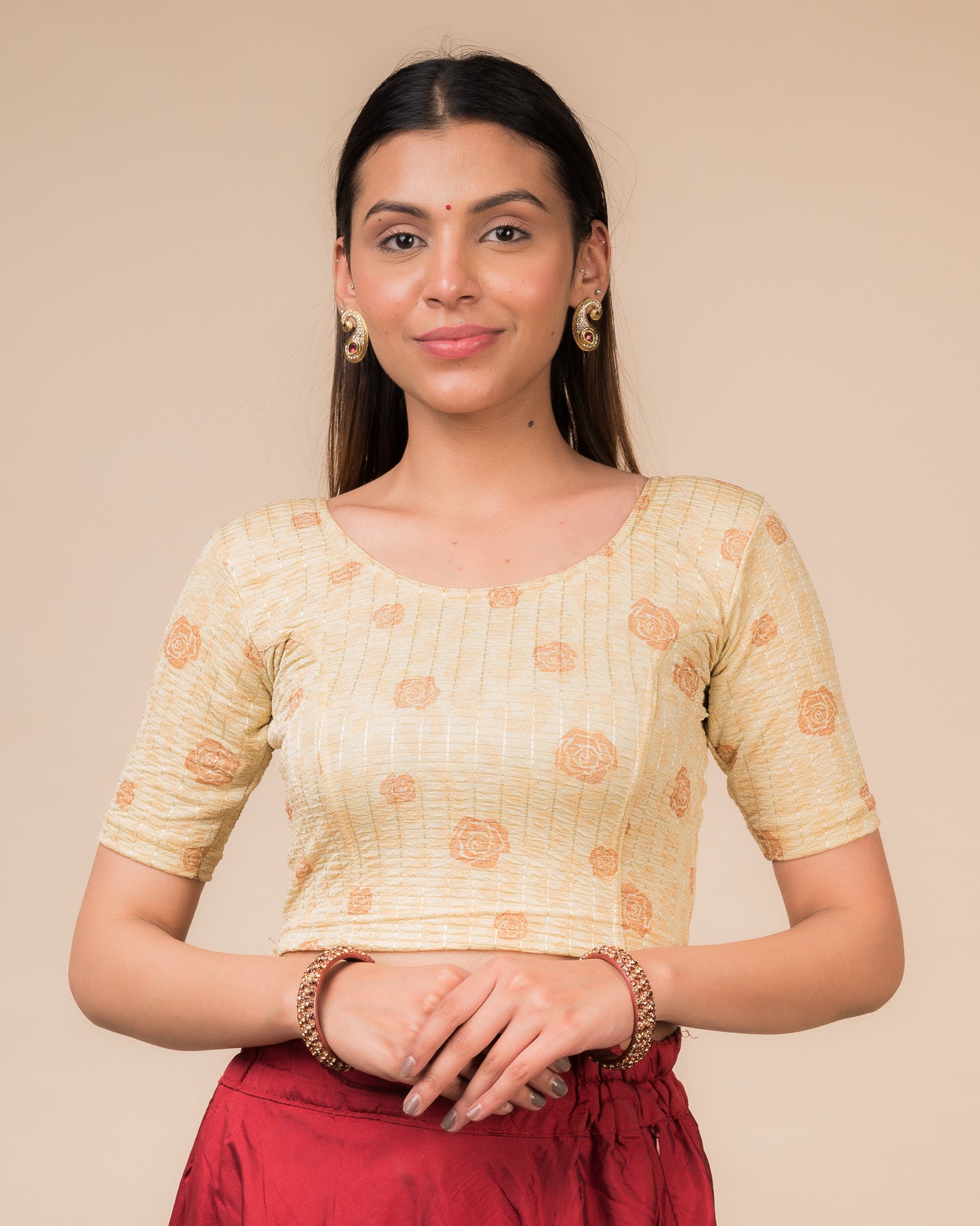 Model wearing a red stretchable blouse with metallic foil floral print, elbow sleeves, and round neckline