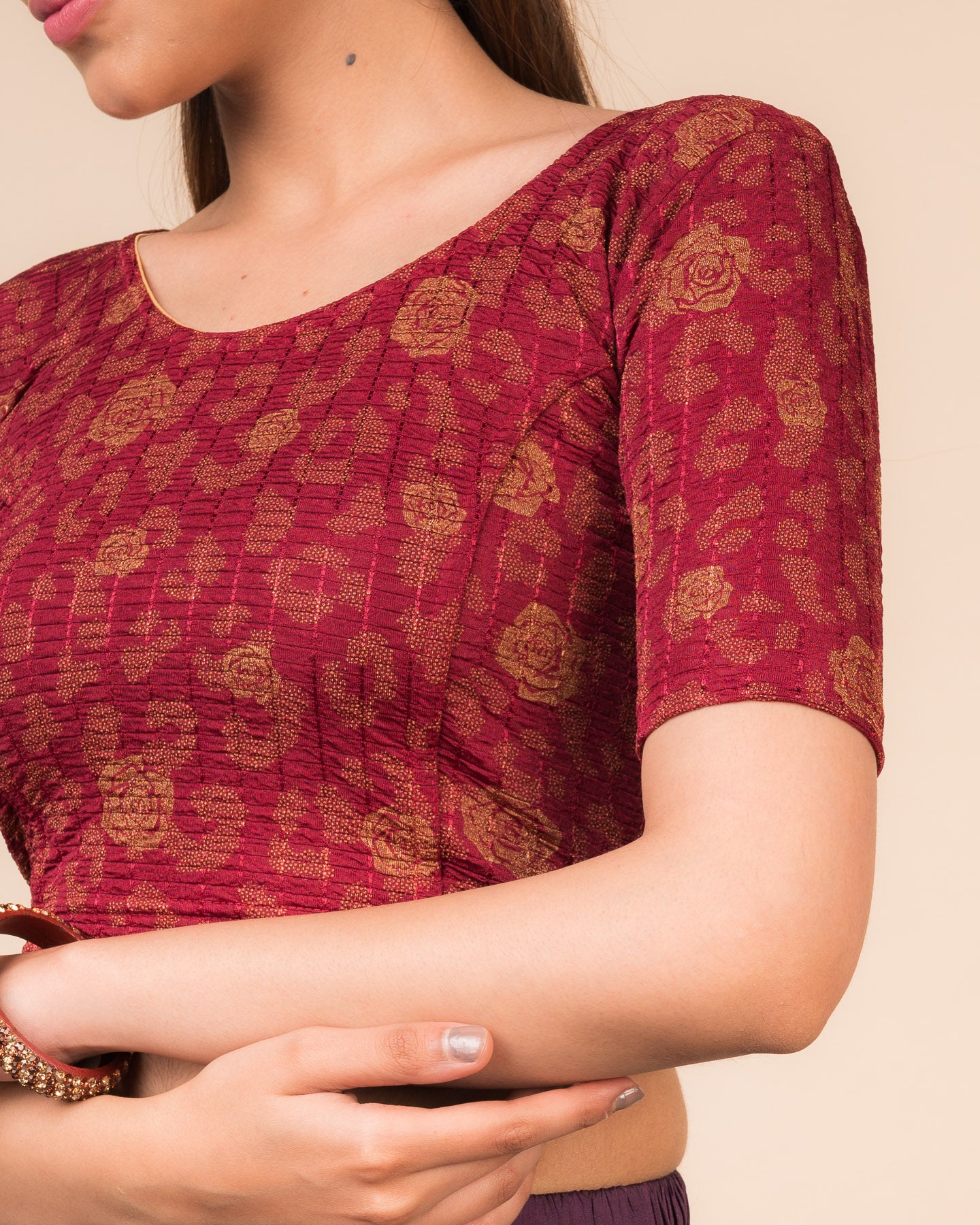 Close-up of the fabric’s metallic floral foil design and stretchable texture
