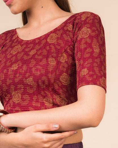 Close-up of the fabric’s metallic floral foil design and stretchable texture