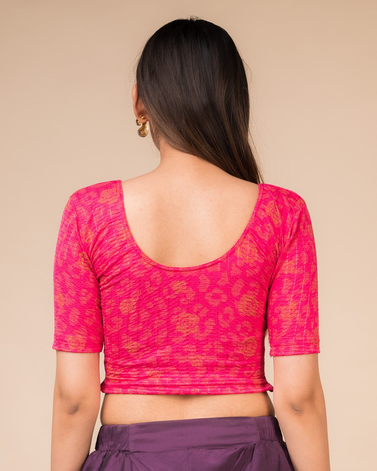 Rear view showcasing the blouse’s slip-on design and back texture
