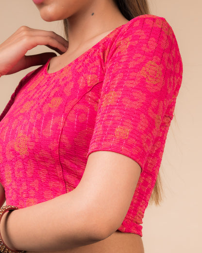 Close-up of the fabric’s metallic floral foil design and stretchable texture