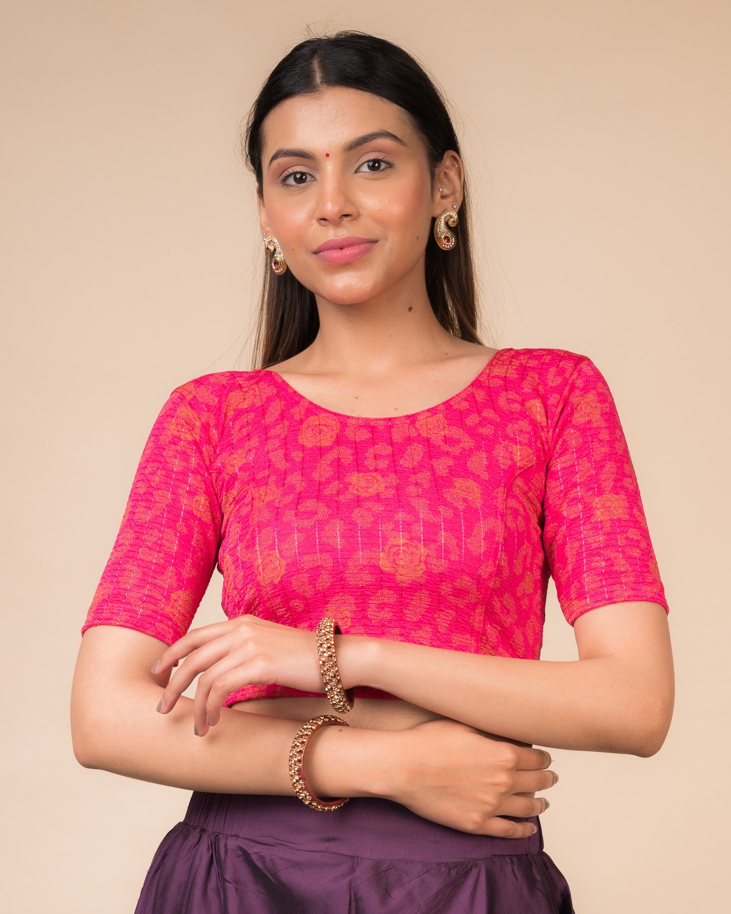 Model wearing a red stretchable blouse with metallic foil floral print, elbow sleeves, and round neckline