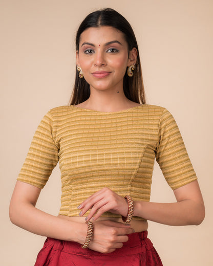 Model wearing a  metallic-striped stretchable blouse with elbow sleeves and boat neckline