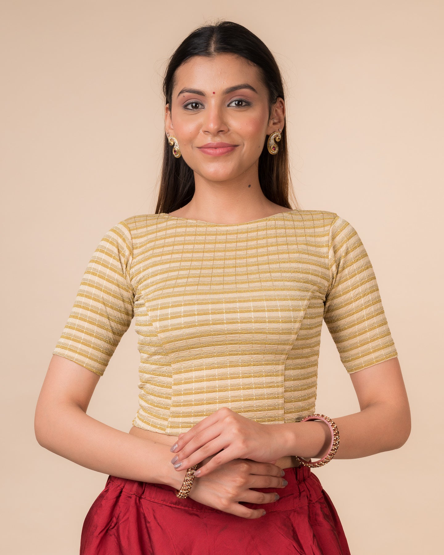 Model wearing a  metallic-striped stretchable blouse with elbow sleeves and boat neckline