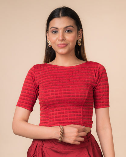 Model wearing a  metallic-striped stretchable blouse with elbow sleeves and boat neckline