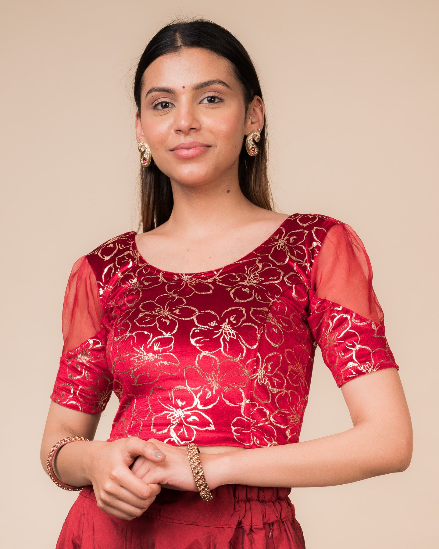 Model wearing a velvet stretchable blouse with floral-sequin embellishments, puff elbow sleeves, and round neckline