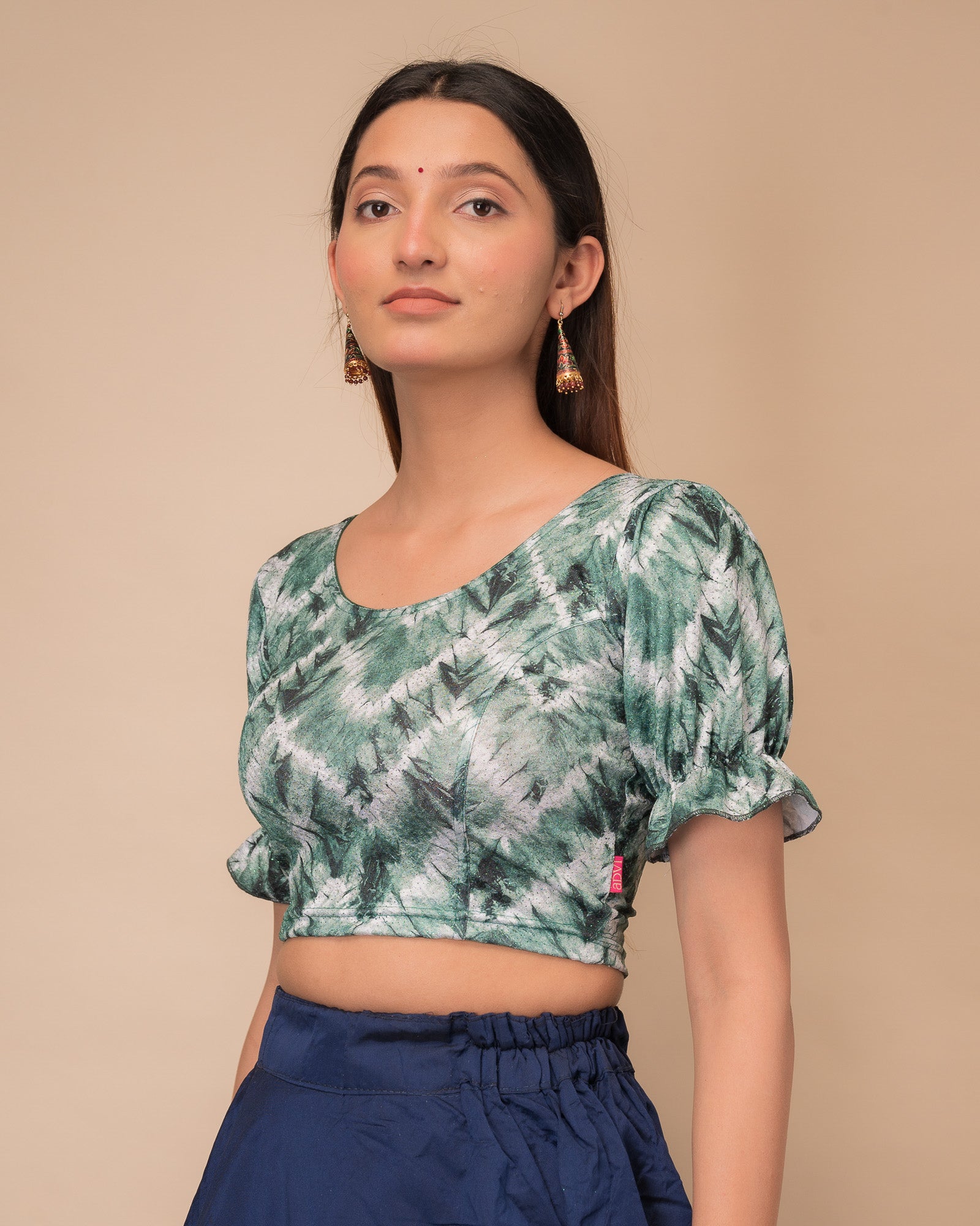 Side profile highlighting the fit, pleated sleeve detail, and tie-dye texture