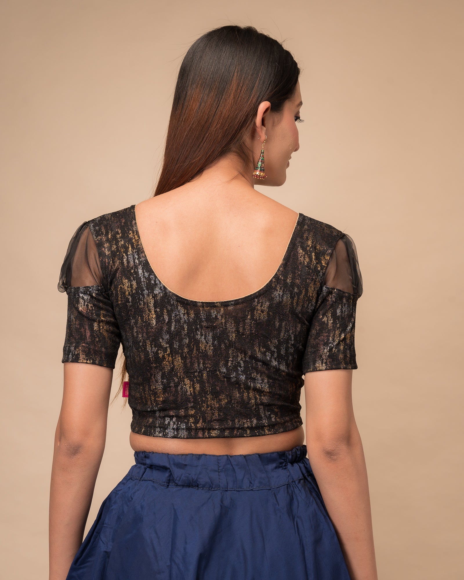  Rear view showing the blouse’s opaque bodice and puffed organza sleeves