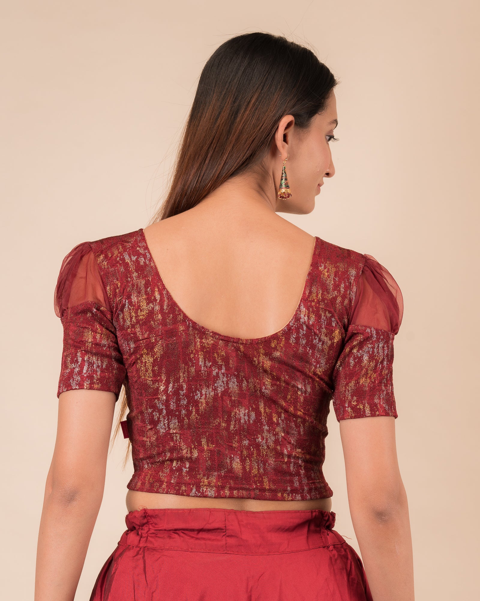  Rear view showing the blouse’s opaque bodice and puffed organza sleeves