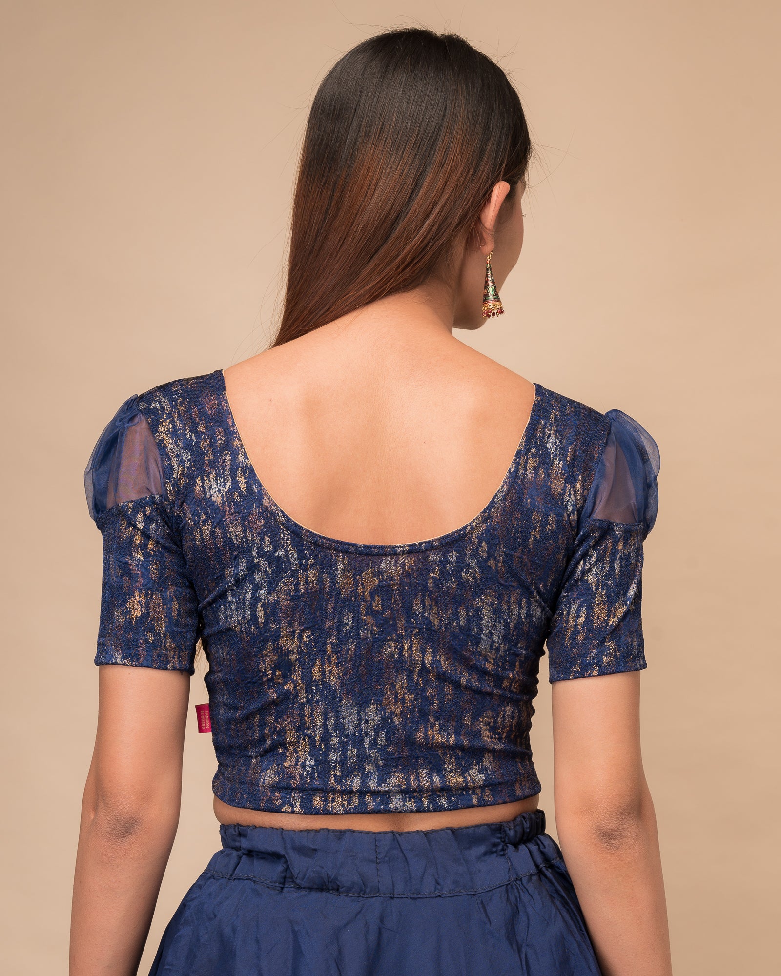  Rear view showing the blouse’s opaque bodice and puffed organza sleeves