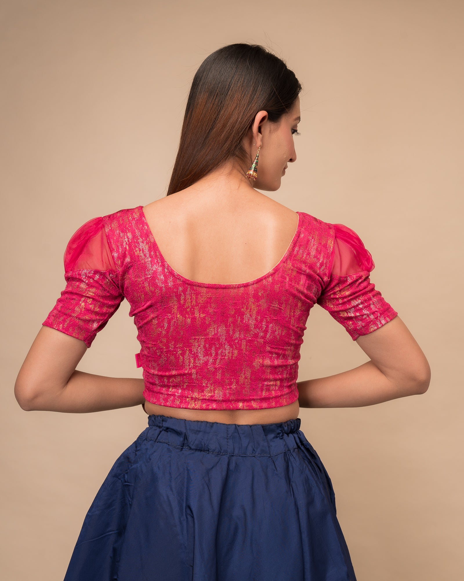  Rear view showing the blouse’s opaque bodice and puffed organza sleeves