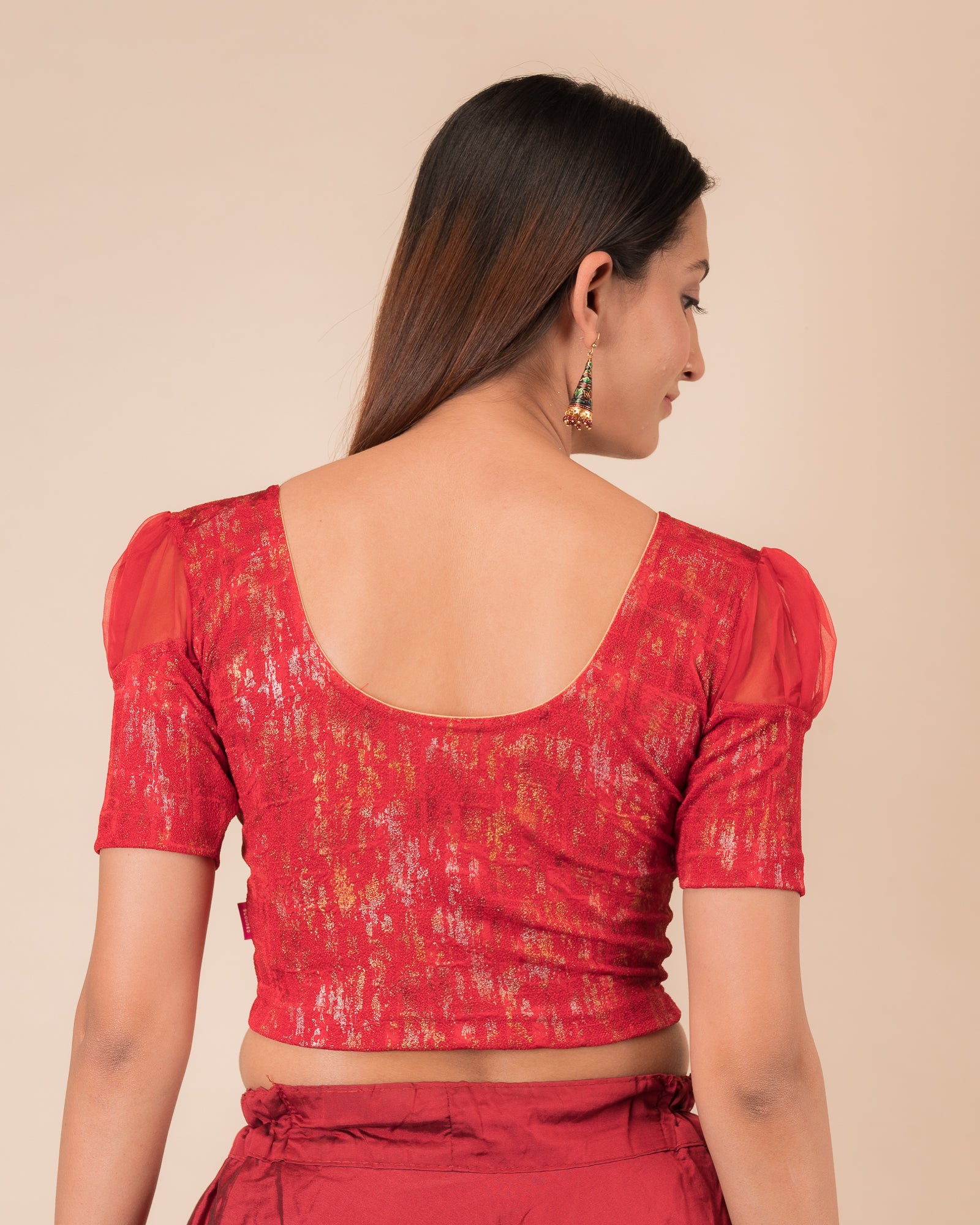  Rear view showing the blouse’s opaque bodice and puffed organza sleeves