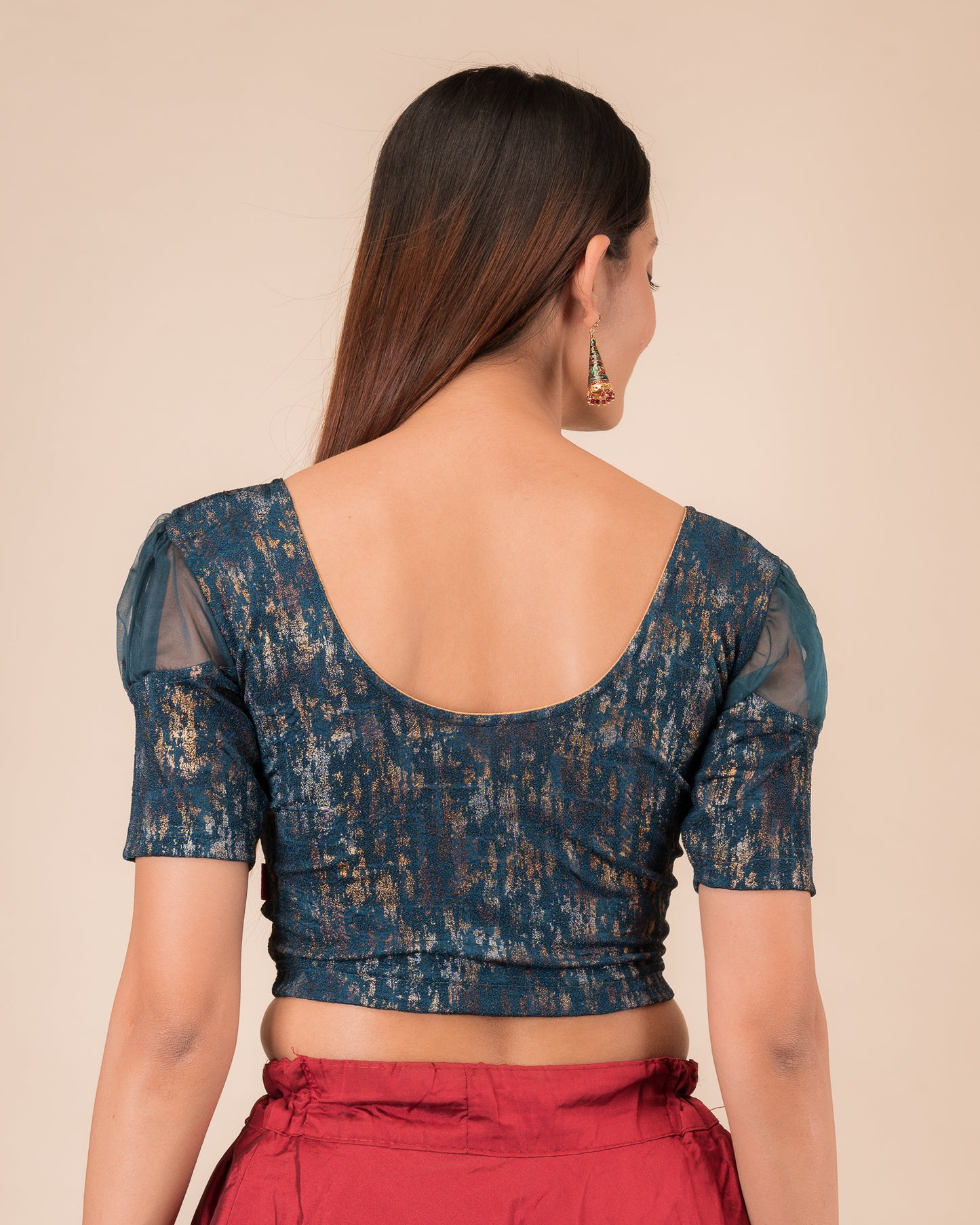  Rear view showing the blouse’s opaque bodice and puffed organza sleeves