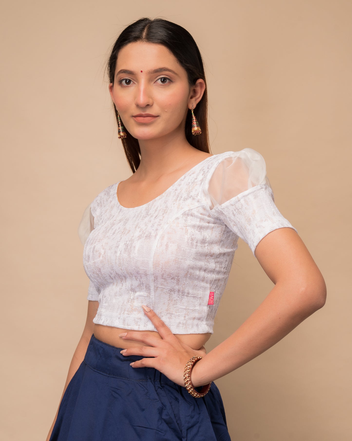 Side profile highlighting the organza puff sleeves and fit