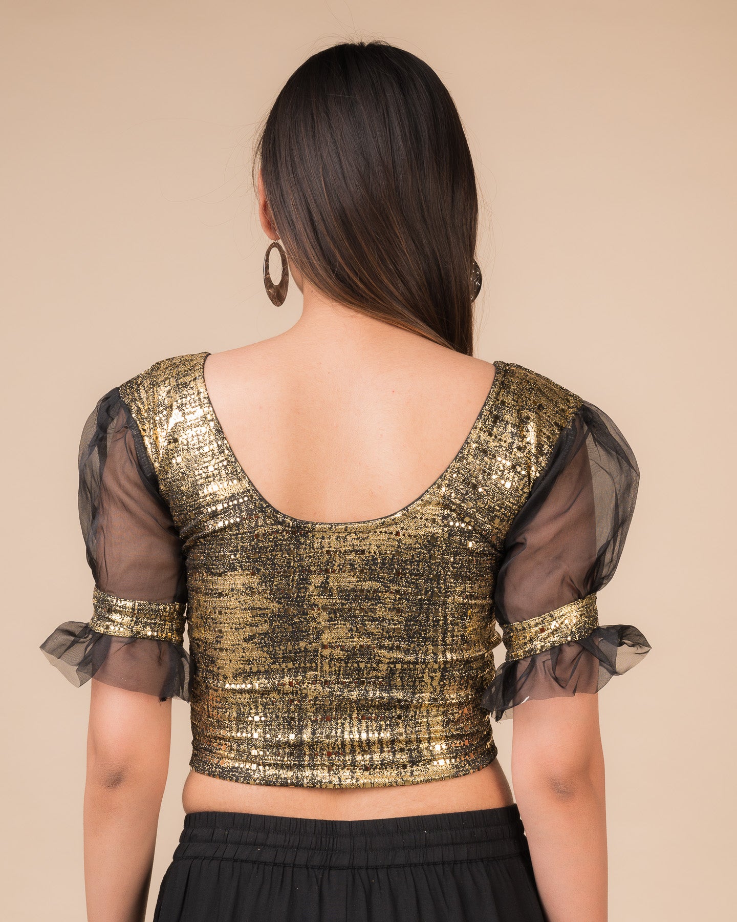 Rear view of the black metallic stretchable blouse showing a rounded back design.