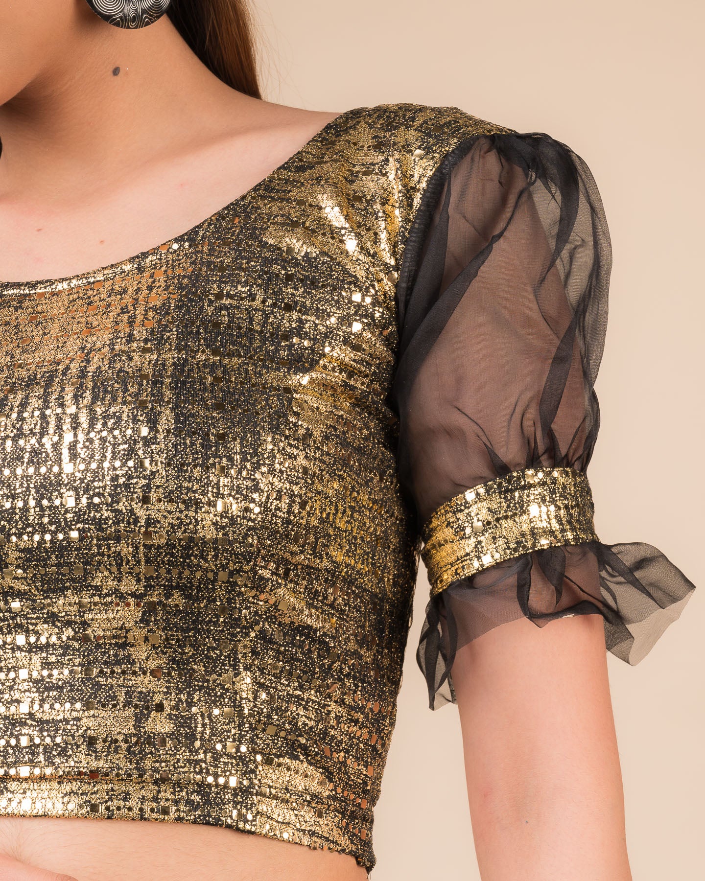 Close-up of the black metallic knit fabric showing its texture and stretchability.