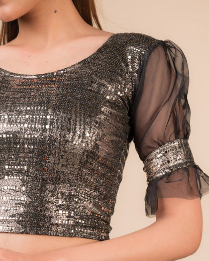 Close-up of the black metallic knit fabric showing its texture and stretchability