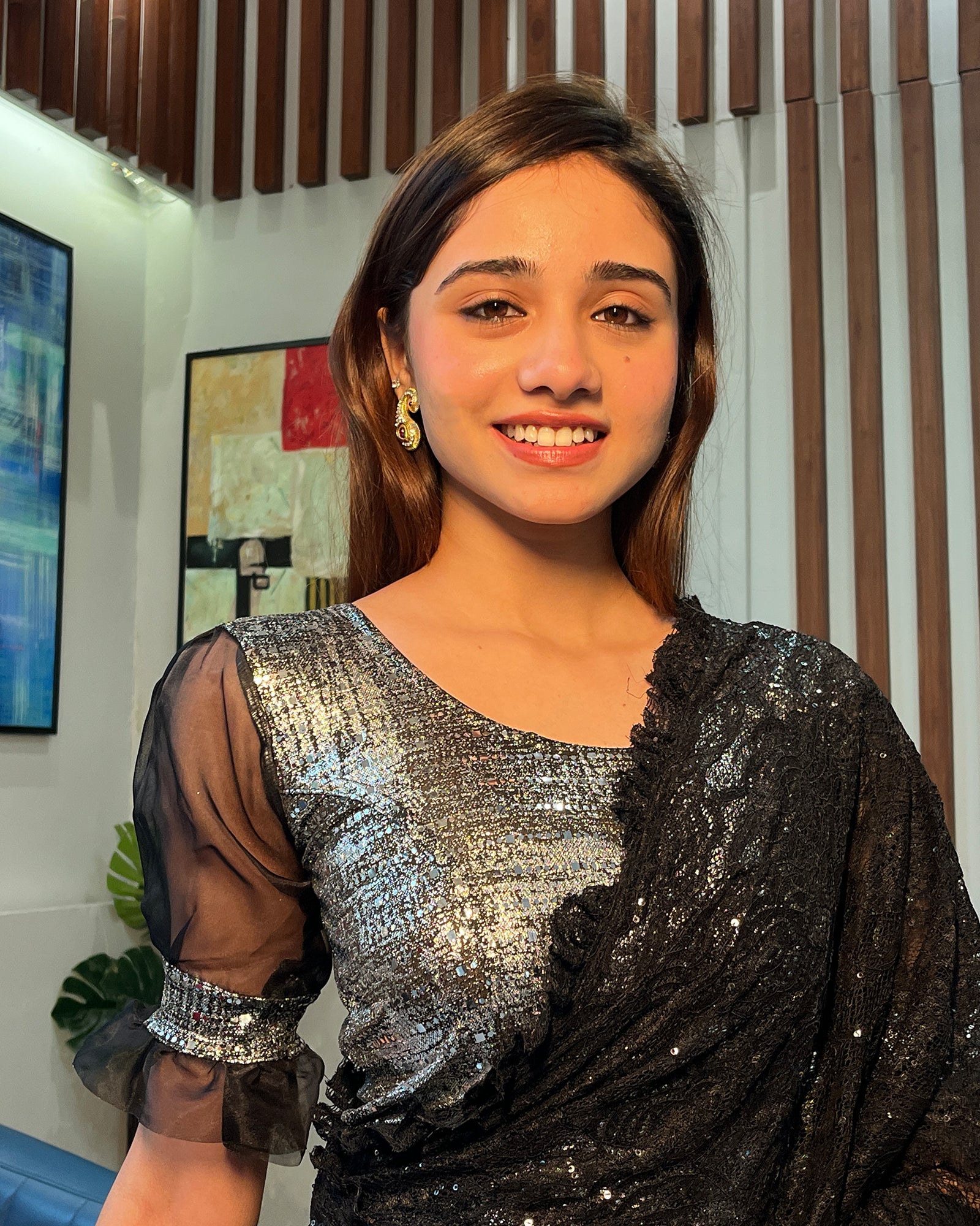 Model pairing the black metallic net stretchable blouse with a traditional saree, demonstrating a complete festive look.