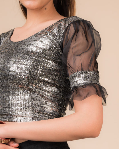 Close-up of the black metallic knit fabric showing its texture and stretchability