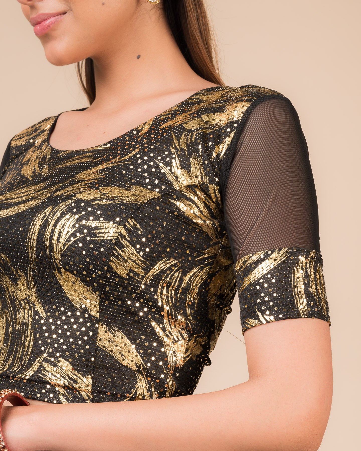 Close-up of the black metallic net fabric detailing the texture and stretchability of the blouse
