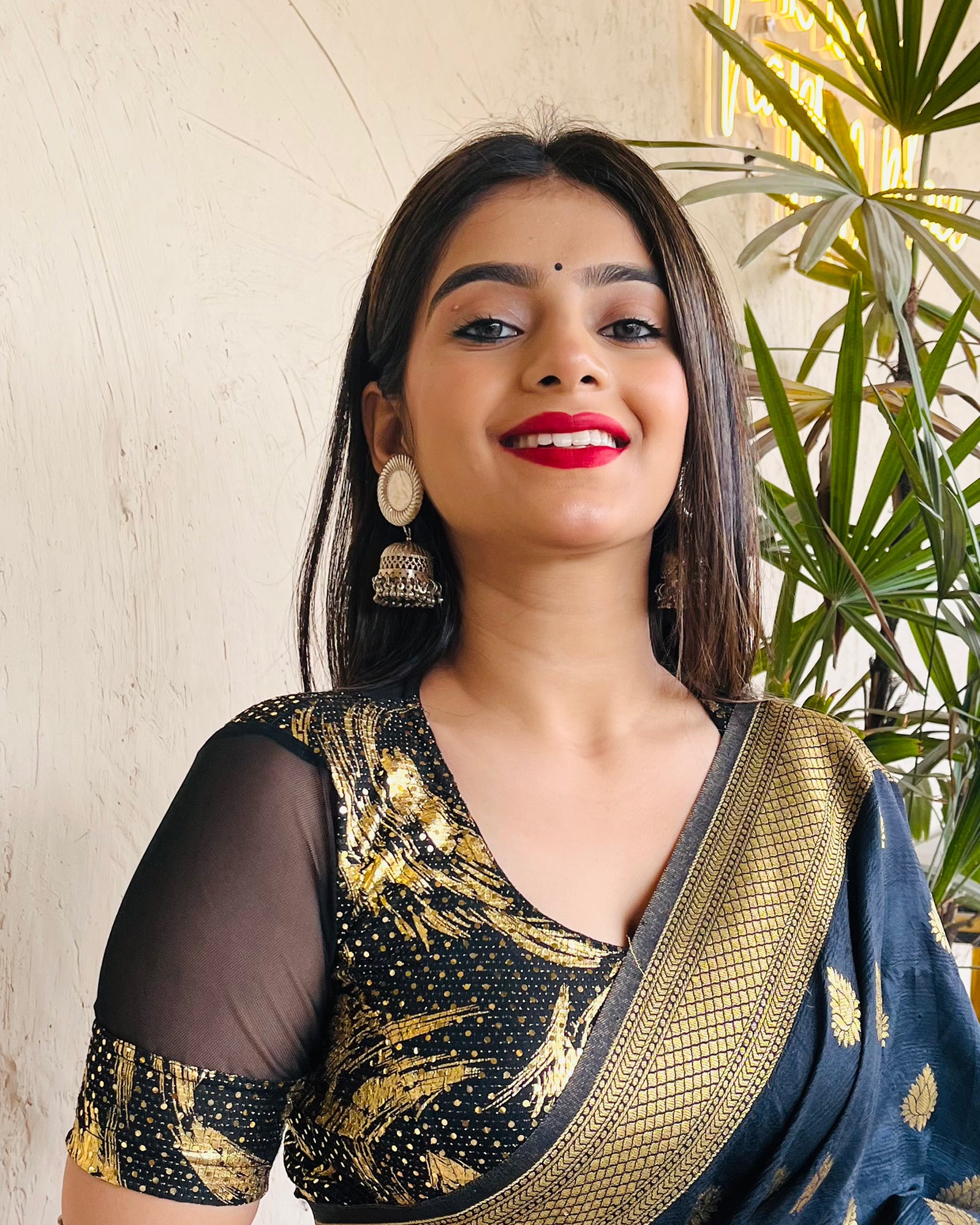Model pairing the black metallic net stretchable blouse with a traditional saree, demonstrating a complete festive look.