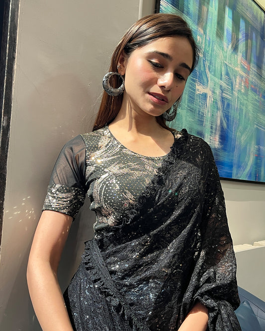 Model pairing the black metallic net stretchable blouse with a traditional saree, demonstrating a complete festive look.