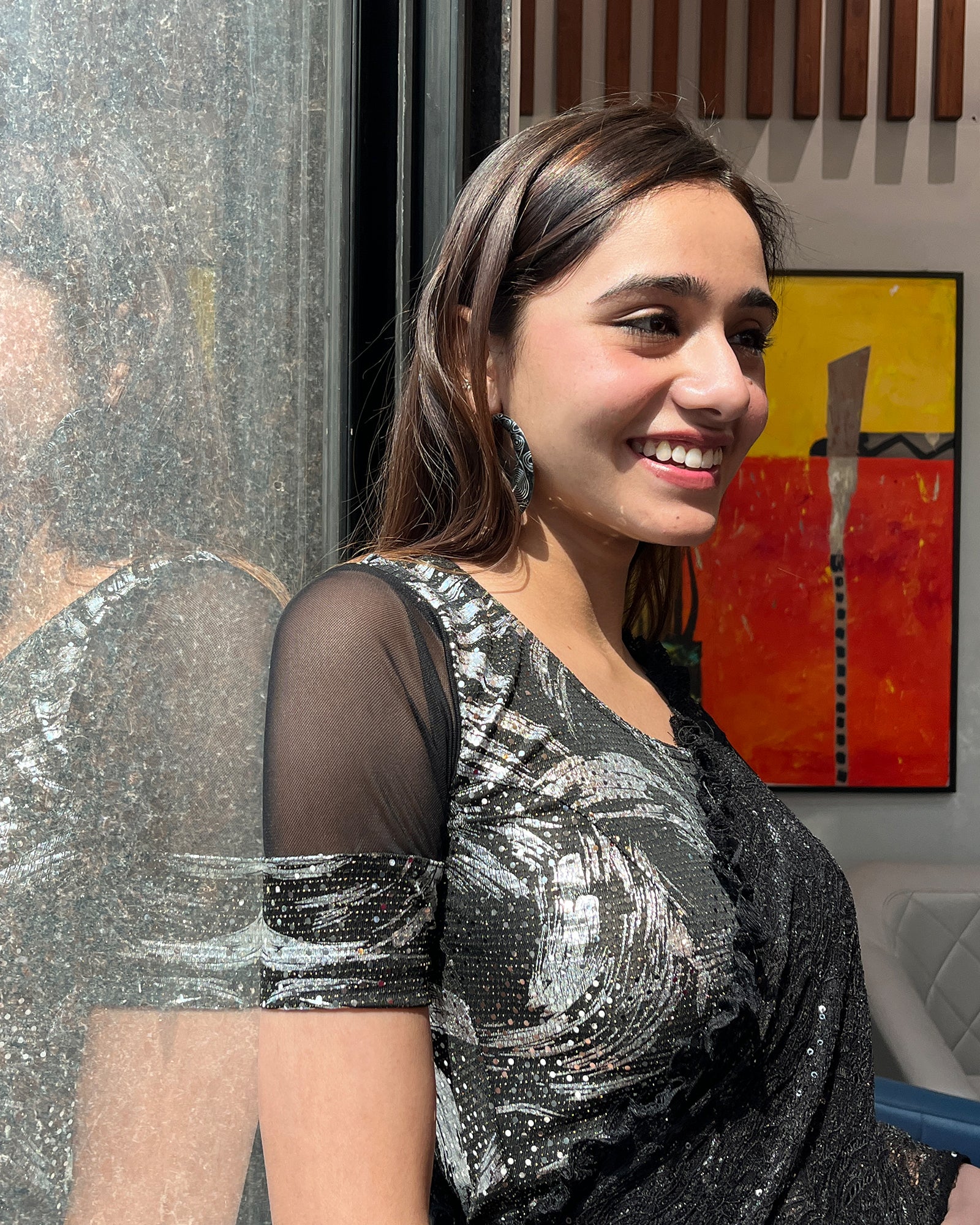 Model pairing the black metallic net stretchable blouse with a traditional saree, demonstrating a complete festive look.