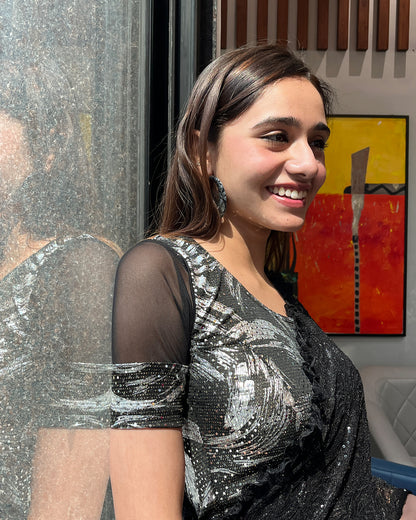 Model pairing the black metallic net stretchable blouse with a traditional saree, demonstrating a complete festive look.