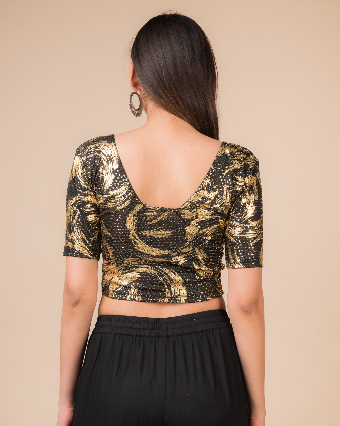 Rear view of the black sequin stretchable blouse showcasing the deep round back design.