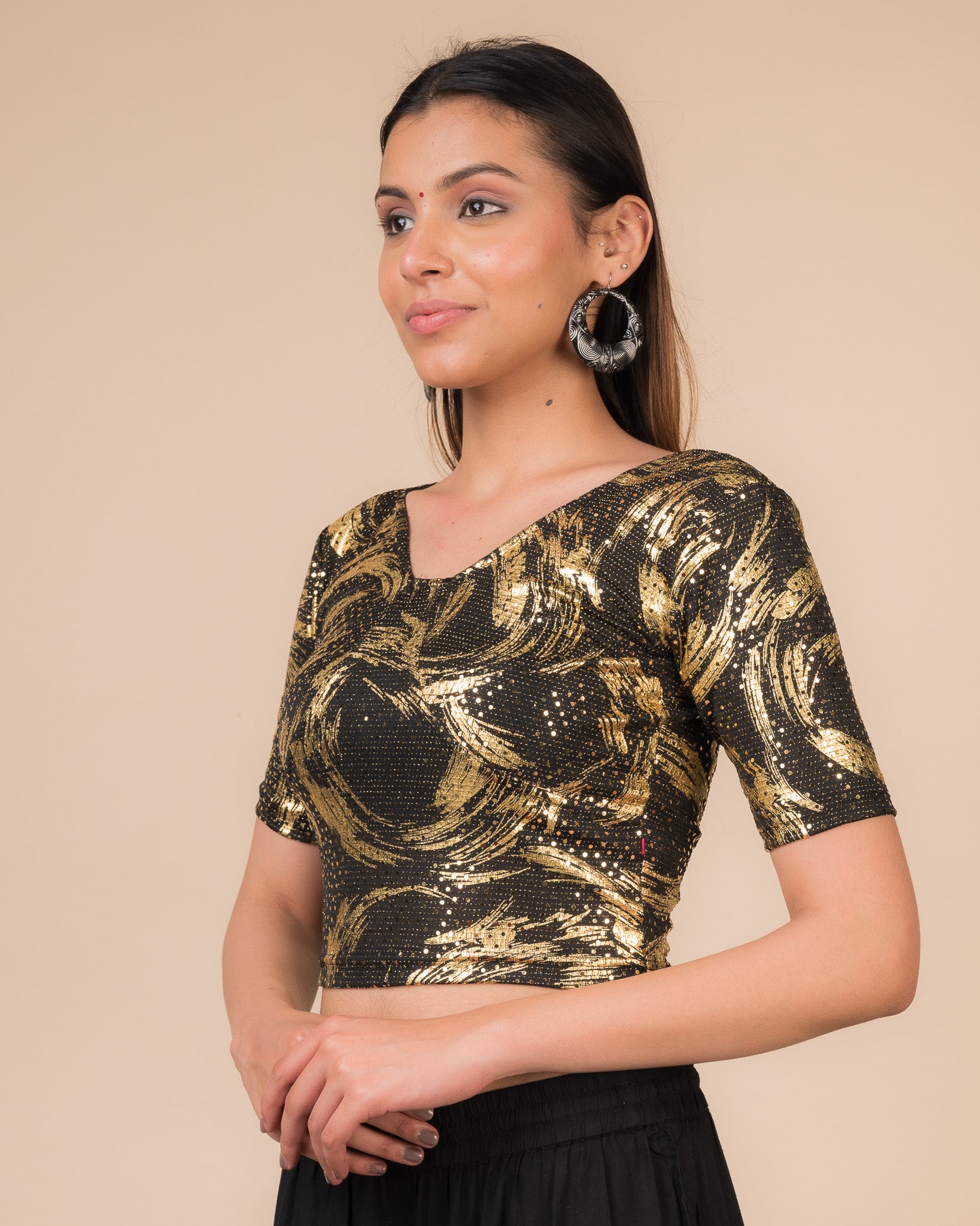 Side profile of the black sequin stretchable blouse highlighting the fit and sleeve length.