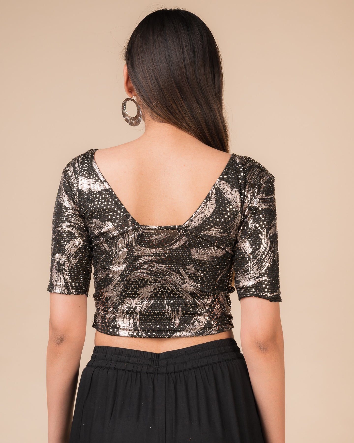 Rear view of the black sequin stretchable blouse showcasing the deep round back design.