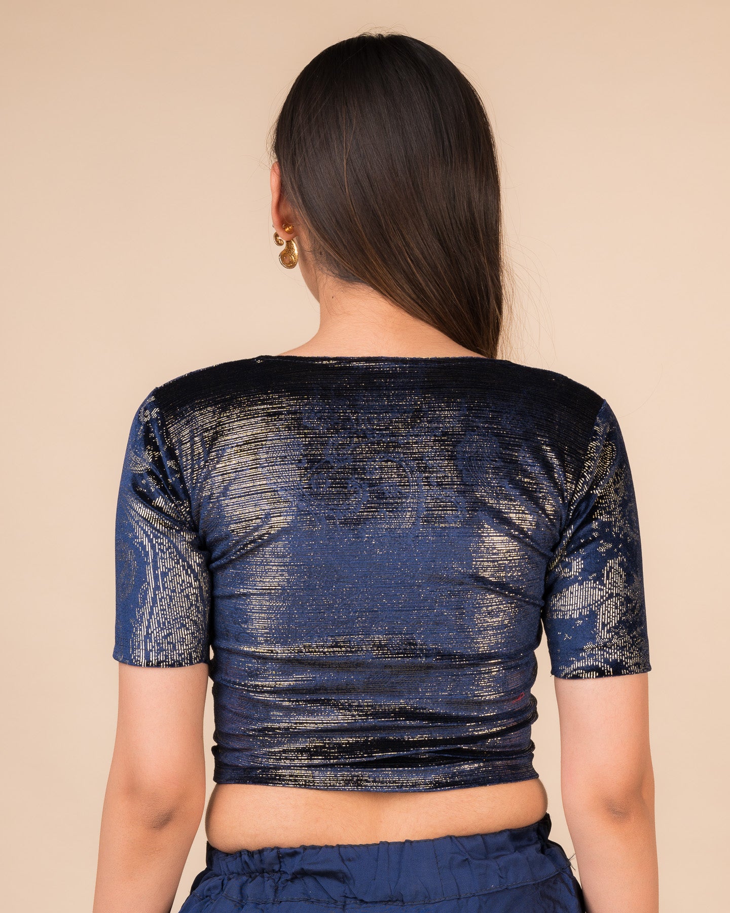 Rear view of the navy-colored velvet embellished stretchable choli-style blouse showcasing the deep round back design.