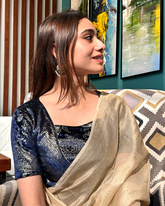 Model pairing the navy-colored velvet embellished stretchable choli-style blouse with a traditional saree, demonstrating a complete festive look.
