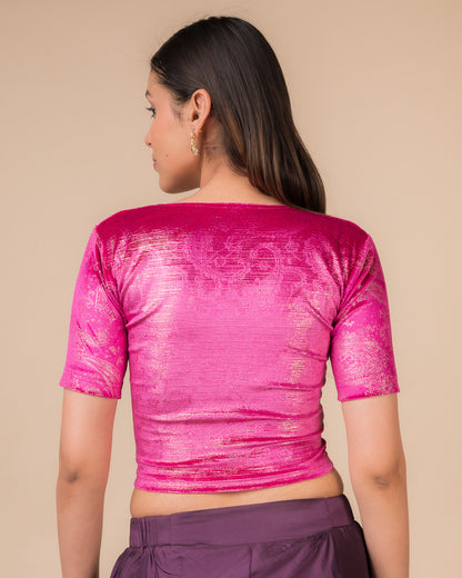Rear view of the rani-colored velvet embellished stretchable choli-style blouse showcasing the deep round back design.
