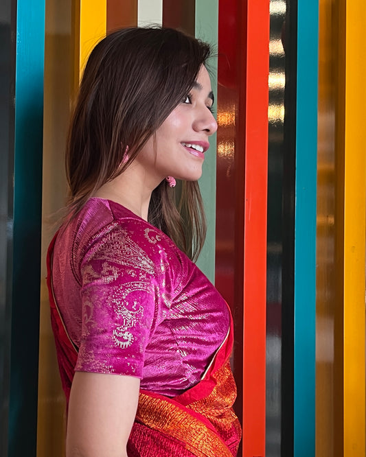 Model pairing the rani-colored velvet embellished stretchable choli-style blouse with a traditional saree, demonstrating a complete festive look.