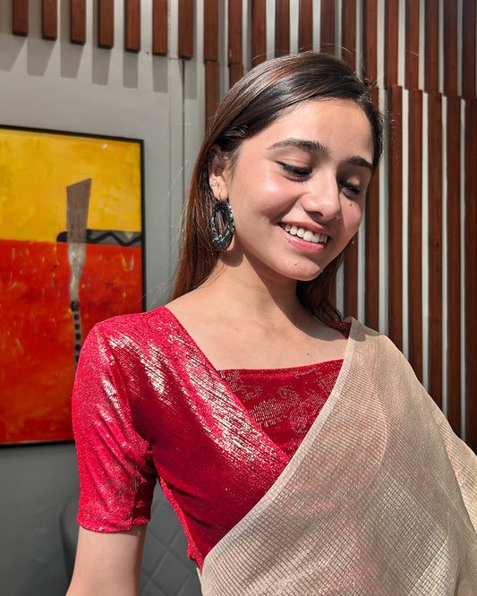 Model pairing the red-colored velvet embellished stretchable choli-style blouse with a traditional saree, demonstrating a complete festive look