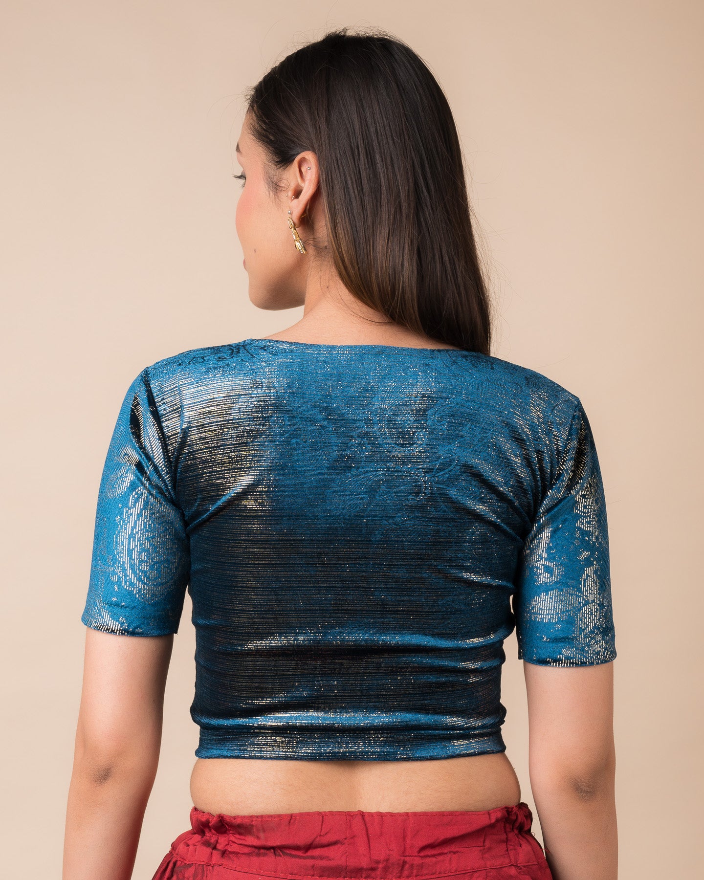 Rear view of the teal blue-colored velvet embellished stretchable choli-style blouse showcasing the deep round back design.
