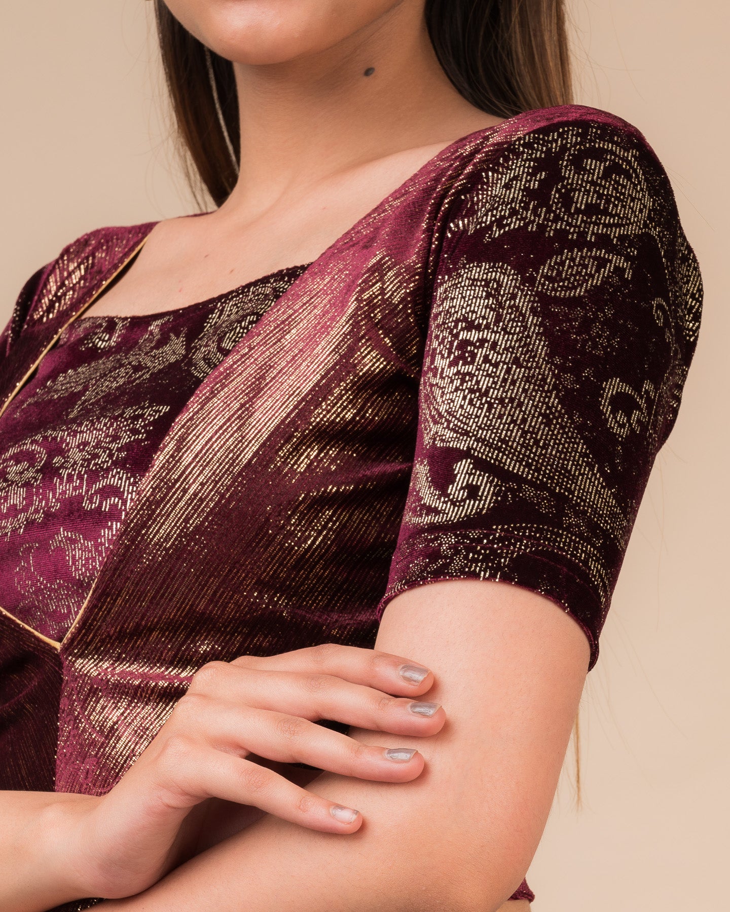 Close-up of the wine-colored velvet fabric detailing the texture and embellishments of the readymade blouse.