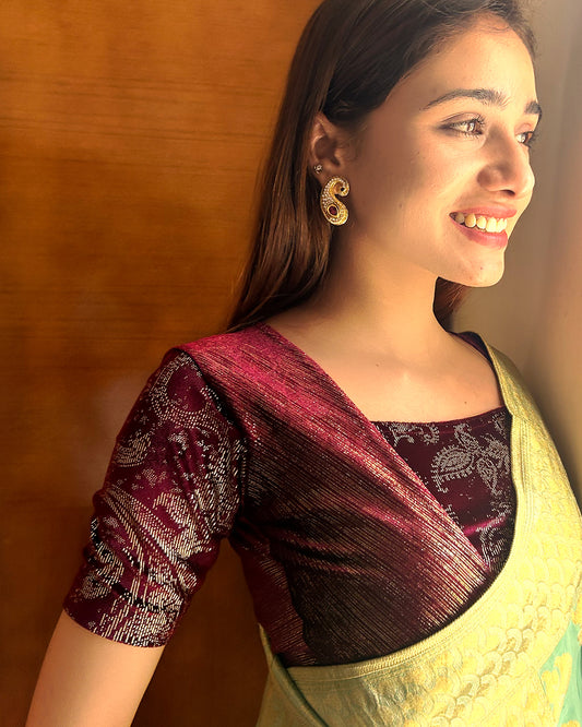 Model pairing the wine-colored velvet embellished stretchable choli-style blouse with a traditional saree, demonstrating a complete festive look.