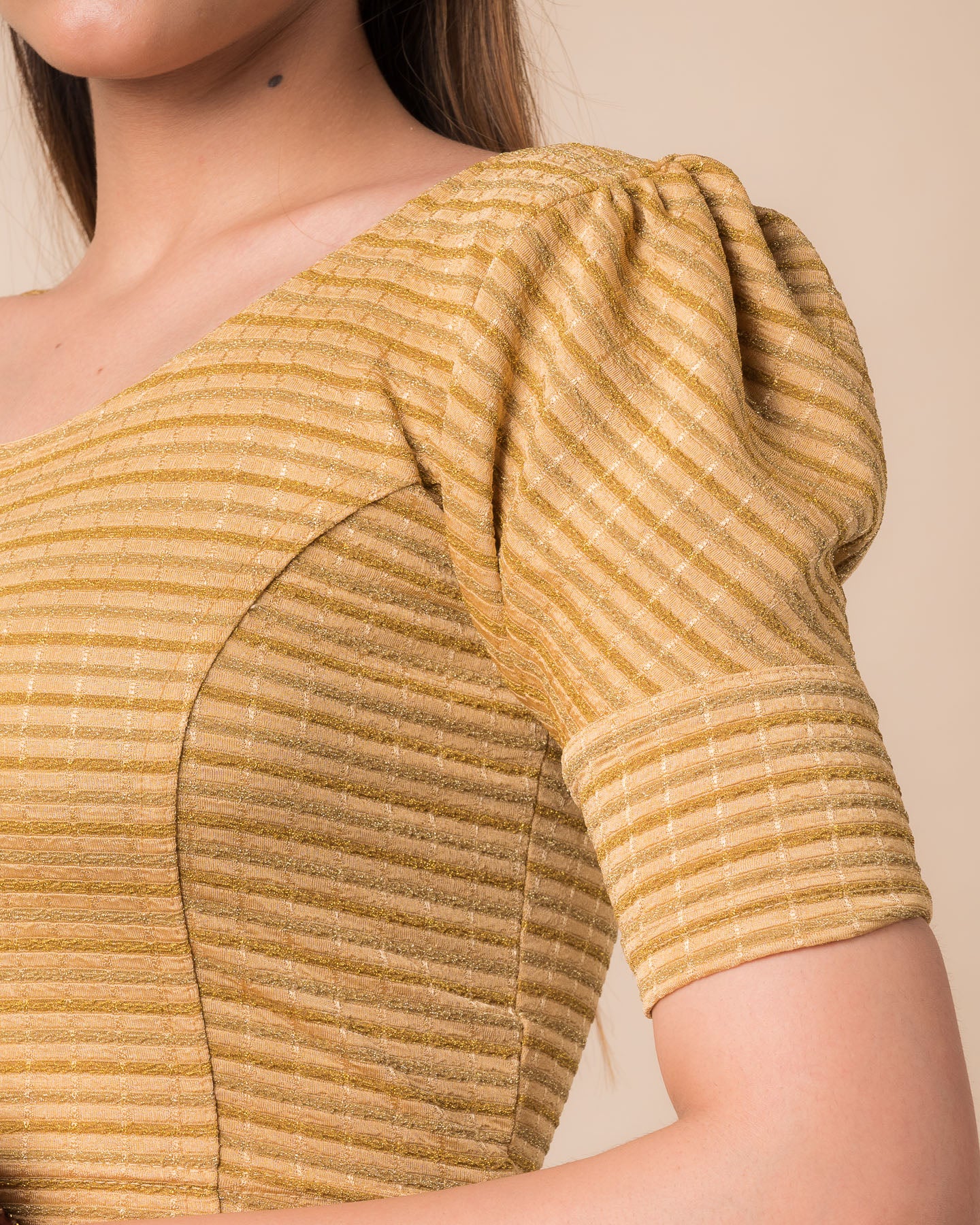  Close-up of the zari single-stripe fabric detailing the texture and stretchability of the readymade blouse.