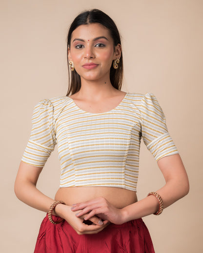 Model wearing a zari single-stripe stretchable readymade blouse with puff elbow sleeves and round neckline.
